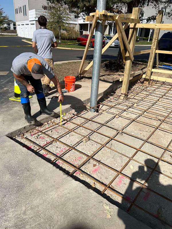 Crew member tying rebar for the dumpster pad