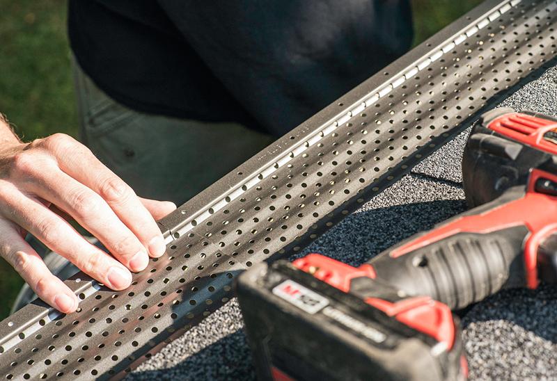 Installer fastening a gutter guard