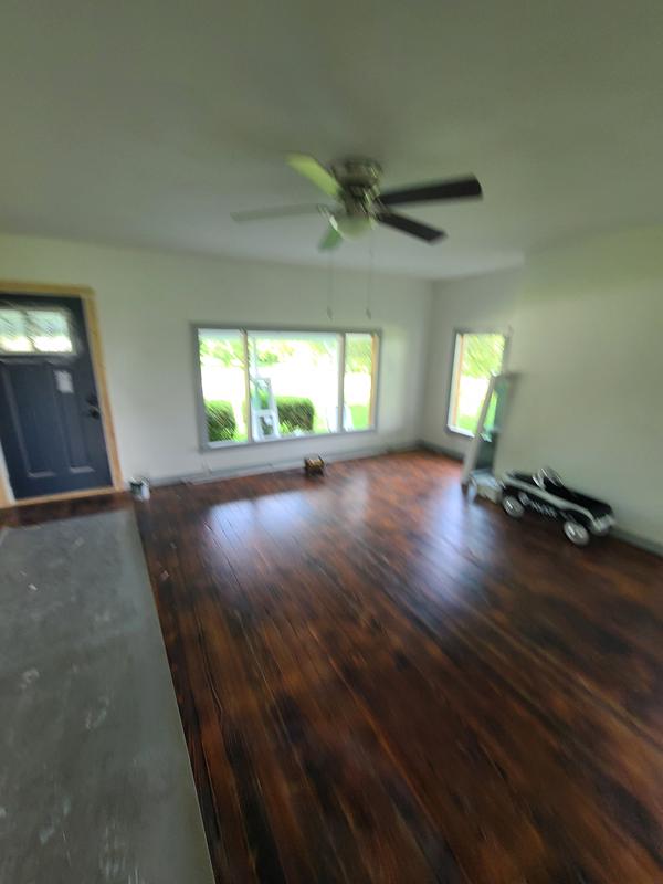 Bright room with refinished hardwood floors and new windows