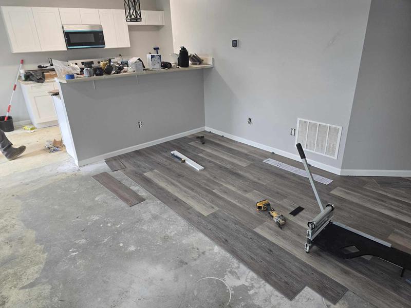 Vinyl plank flooring being installed in the kitchen