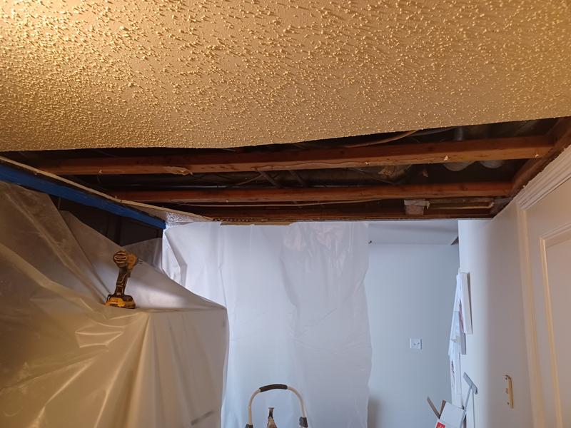 Room sealed off with plastic sheeting and the ceiling opened up during remediation