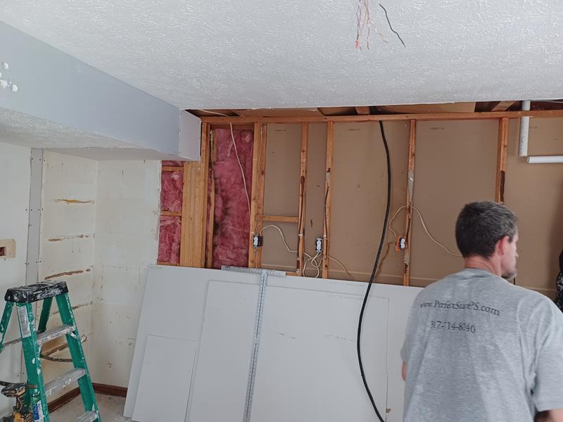 New drywall going up on an opened wall